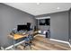 Bedroom area is staged as an office space and features dark gray walls and sleek vinyl floors at 3046 W New York St, Indianapolis, IN 46222