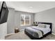 Neutral bedroom with a large window and a comfortable bed with decorative throw pillows at 3046 W New York St, Indianapolis, IN 46222