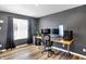 Bedroom area is staged as an office space and features dark gray walls and sleek vinyl floors at 3046 W New York St, Indianapolis, IN 46222