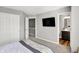Bedroom features a walk-in closet, en suite bathroom, and a television at 3046 W New York St, Indianapolis, IN 46222
