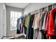 Walk-in closet with window, rod, and shelving provides ample storage space at 3046 W New York St, Indianapolis, IN 46222