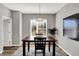 Bright dining area features dark wood table, modern lighting and a decorative city map at 3046 W New York St, Indianapolis, IN 46222