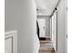Hallway features a grey wall, wood floors, white doors, dark stairs and modern lighting at 3046 W New York St, Indianapolis, IN 46222