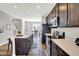 Modern kitchen with stainless steel appliances, dark cabinets, a center island and white quartz countertops at 3046 W New York St, Indianapolis, IN 46222