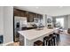 Open concept kitchen with stainless steel appliances, a large island with breakfast bar, and ample cabinet space at 3046 W New York St, Indianapolis, IN 46222
