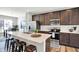 This kitchen features a central island with quartz countertops, modern appliances, and a cozy breakfast bar at 3046 W New York St, Indianapolis, IN 46222