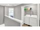 Convenient upstairs laundry area with washer, dryer, and storage shelves at 3046 W New York St, Indianapolis, IN 46222