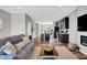 Inviting living room with fireplace, comfortable seating, and open access to a modern kitchen at 3046 W New York St, Indianapolis, IN 46222