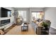 Bright living room with fireplace, large television, comfortable seating, and plenty of natural light at 3046 W New York St, Indianapolis, IN 46222