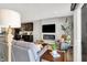 A stylish living room featuring a fireplace, a large TV, and comfortable seating adjacent to the kitchen at 3046 W New York St, Indianapolis, IN 46222