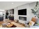 Cozy living room featuring a modern fireplace, a large TV, and comfortable seating next to the kitchen at 3046 W New York St, Indianapolis, IN 46222