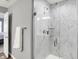 Walk-in shower boasts marble-style tiling, glass doors, and modern fixtures at 3046 W New York St, Indianapolis, IN 46222