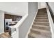 Carpeted staircase leading to upper level, adjacent to the modern kitchen at 3046 W New York St, Indianapolis, IN 46222