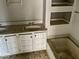 A bathroom featuring a double sink vanity, a bathtub, and white tiled shelves at 3132 E 36Th St, Indianapolis, IN 46218