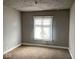 A bedroom with a window, neutral walls, and carpeted floors at 3132 E 36Th St, Indianapolis, IN 46218