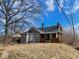 Two-story home features brick accents, a covered front porch, and a mature shade tree at 3132 E 36Th St, Indianapolis, IN 46218