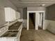 A kitchen with a sink, cabinets, and staircase at 3132 E 36Th St, Indianapolis, IN 46218