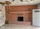 The living room features a brick fireplace, a white door, and neutral carpeting at 3132 E 36Th St, Indianapolis, IN 46218