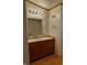 Bathroom vanity with a mirror and lights, reflecting a bathtub, and a white countertop at 3336 Fall Valley Dr, Columbus, IN 47203