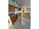 Well-lit kitchen featuring a white island, wood cabinets, and stainless steel appliances at 3336 Fall Valley Dr, Columbus, IN 47203