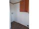 Cozy laundry area with wood cabinets for storage and connections for a washer and dryer at 3336 Fall Valley Dr, Columbus, IN 47203