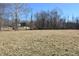 Spacious backyard with a tree lined perimeter and a home in the background at 3546 Stierwalt Rd, Quincy, IN 47456