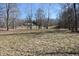 Spacious backyard with a tree lined perimeter and a home in the background at 3546 Stierwalt Rd, Quincy, IN 47456