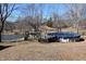 A backyard with a wooden deck, an above ground pool and beautiful surrounding landscape at 3546 Stierwalt Rd, Quincy, IN 47456