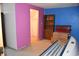 A basement area featuring purple and blue painted walls, a closet and an old tanning bed at 3546 Stierwalt Rd, Quincy, IN 47456