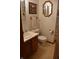 Compact bathroom features a vanity with a sink, toilet, and mirrored medicine cabinet at 3546 Stierwalt Rd, Quincy, IN 47456