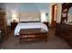 A charming bedroom with a king bed and vintage wooden furniture at 3546 Stierwalt Rd, Quincy, IN 47456