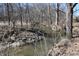 Calm creek view nestled among bare trees and undergrowth at 3546 Stierwalt Rd, Quincy, IN 47456