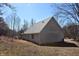 View of the rear of the home showing the siding and roof on a sunny day at 3546 Stierwalt Rd, Quincy, IN 47456