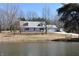 Charming exterior view of home, featuring a picturesque pond and lush greenery at 3546 Stierwalt Rd, Quincy, IN 47456