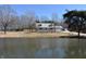Home and pond view featuring beautiful trees and a sprawling landscape at 3546 Stierwalt Rd, Quincy, IN 47456