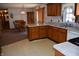 Open-concept kitchen with wood cabinetry, flowing into the dining area for seamless entertaining at 3546 Stierwalt Rd, Quincy, IN 47456