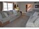 Inviting living room featuring three sofas, carpet floors, and natural light at 3546 Stierwalt Rd, Quincy, IN 47456