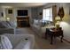 Comfortable living room featuring carpet floors, natural light, and a fireplace at 3546 Stierwalt Rd, Quincy, IN 47456