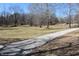 Gravel path and expansive backyard with treeline at 3546 Stierwalt Rd, Quincy, IN 47456