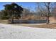 A full view of the pond surrounded by trees and lush green grass at 3546 Stierwalt Rd, Quincy, IN 47456