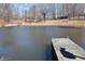 Full view of a pond with a dock and surrounding woodland at 3546 Stierwalt Rd, Quincy, IN 47456
