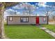 Charming home featuring a red front door, well-maintained lawn and curb appeal at 4159 N Ridgeview Dr, Indianapolis, IN 46226