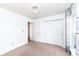 A carpeted bedroom features a large closet and a modern chandelier at 4829 Penoyer Ln, Indianapolis, IN 46235