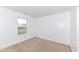 A carpeted bedroom features a window bringing in lots of natural light at 4829 Penoyer Ln, Indianapolis, IN 46235