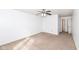 The bedroom boasts neutral carpeting, a ceiling fan, and a view of the hallway at 4829 Penoyer Ln, Indianapolis, IN 46235