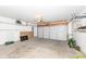 A spacious garage includes an automatic garage door and shelving for storage at 4829 Penoyer Ln, Indianapolis, IN 46235