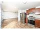 Open-concept kitchen flows to the living room and features modern stainless-steel appliances at 4829 Penoyer Ln, Indianapolis, IN 46235
