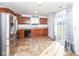 Modern kitchen with dark cabinets, tile backsplash, stainless steel appliances, and a sliding patio door at 4829 Penoyer Ln, Indianapolis, IN 46235