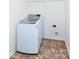 A laundry room offers tile floor and a front load washing machine at 4829 Penoyer Ln, Indianapolis, IN 46235