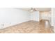 Bright living room boasting tile floors, a ceiling fan, and a seamless transition to the entry hallway at 4829 Penoyer Ln, Indianapolis, IN 46235